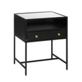 A black nightstand with a glass top and gold-colored hardware, featuring one drawer and an open shelf beneath.
